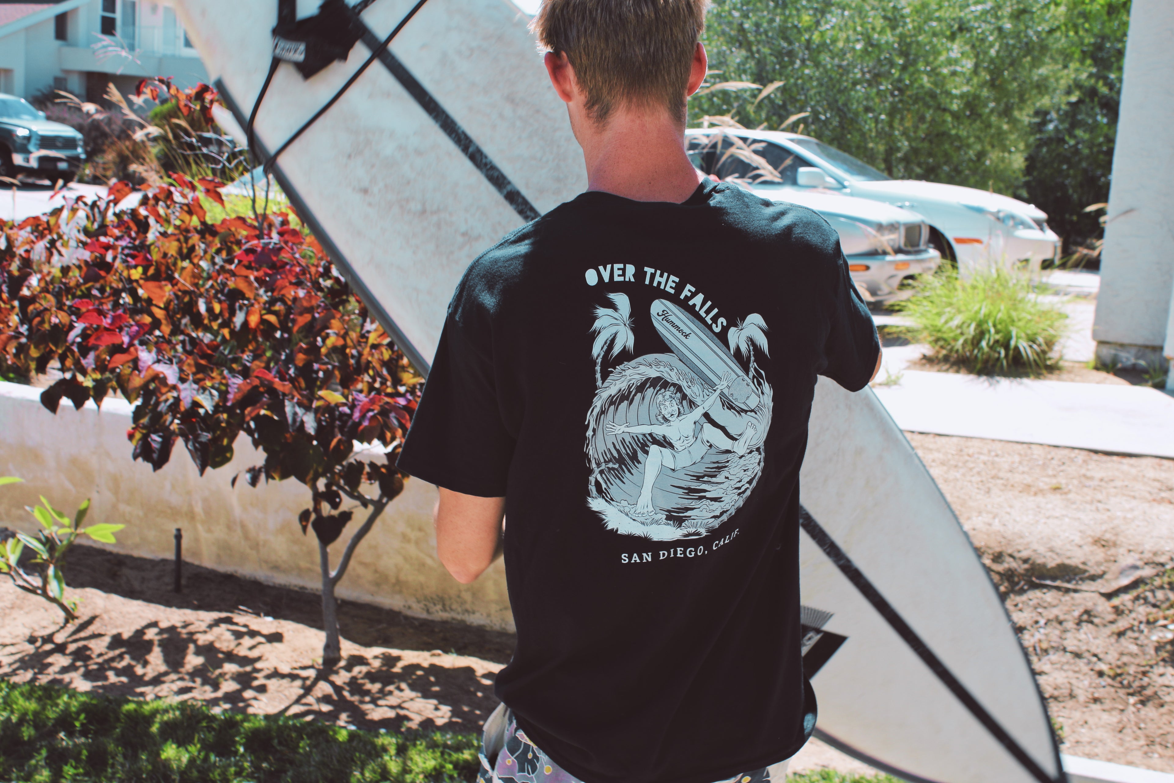 Surfer wearing Hummock Surf Supply Over the Falls tee in Encinitas